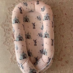 Deluxe DockATot with circus cover and additional green geometric shape cover.